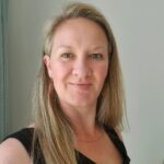 a white lady in a black top with blond hair